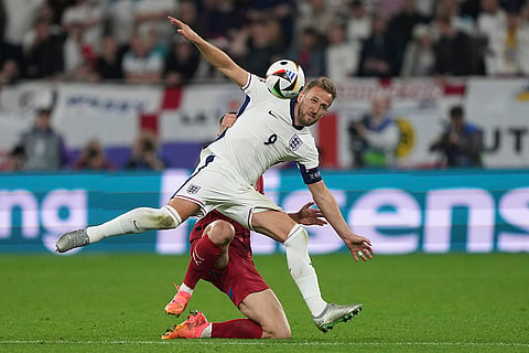 Harry Kane duels for the ball with Nikola Milenkovic 